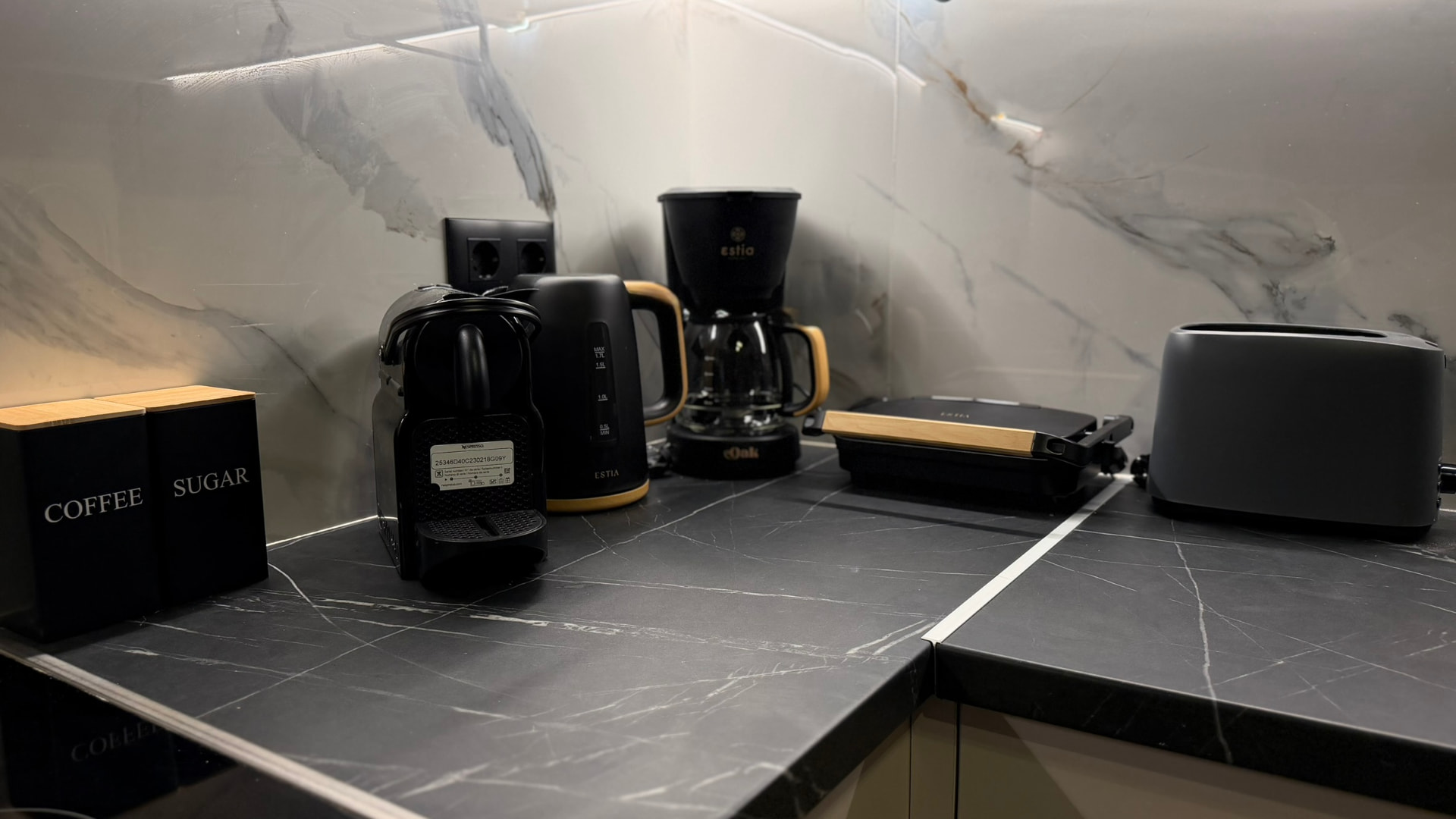 Kitchen counter with coffee machine, kettle, toaster and coffee and sugar jars