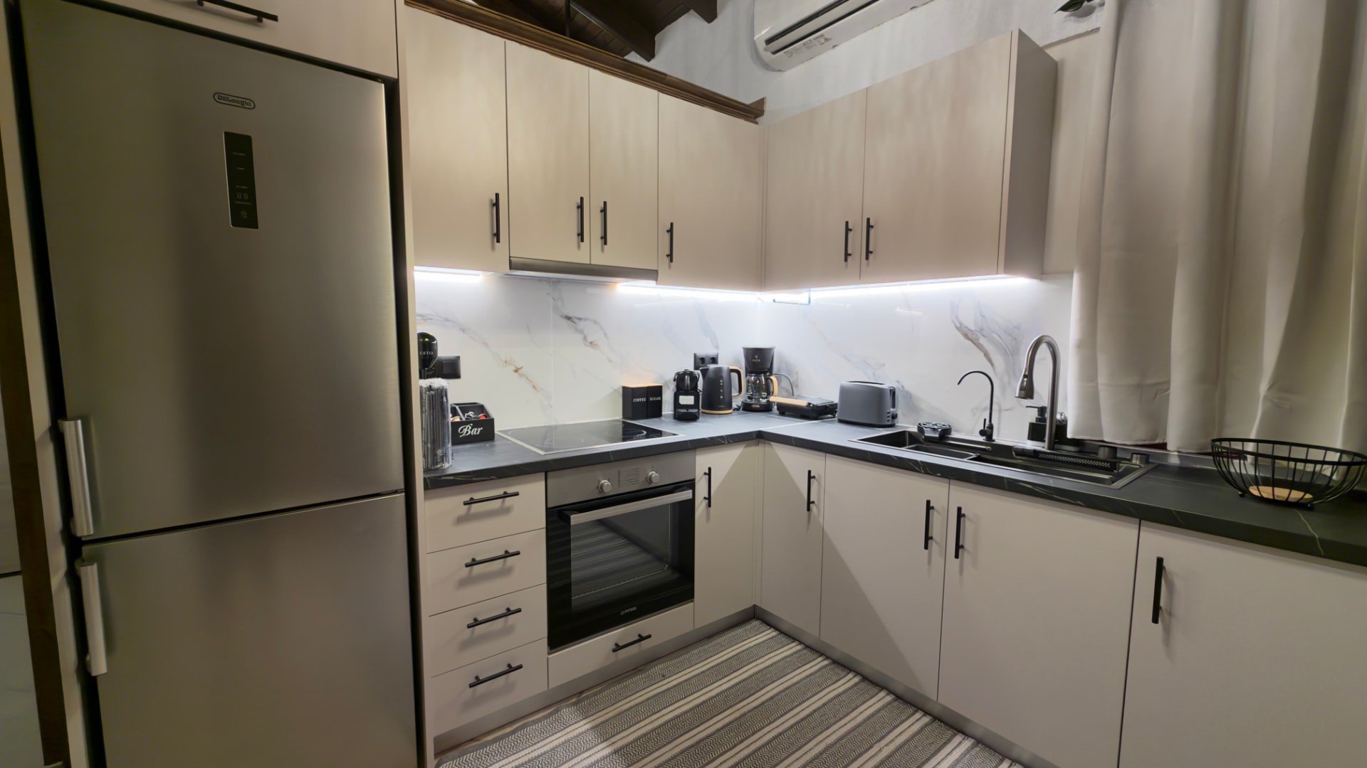 Kitchen with fridge, oven, hob and sink