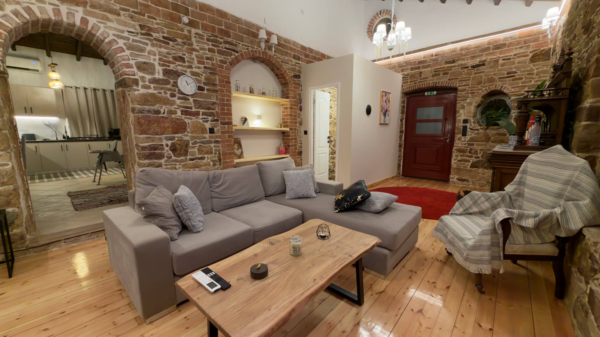 Corner sofa and wooden coffee table under a stone arch